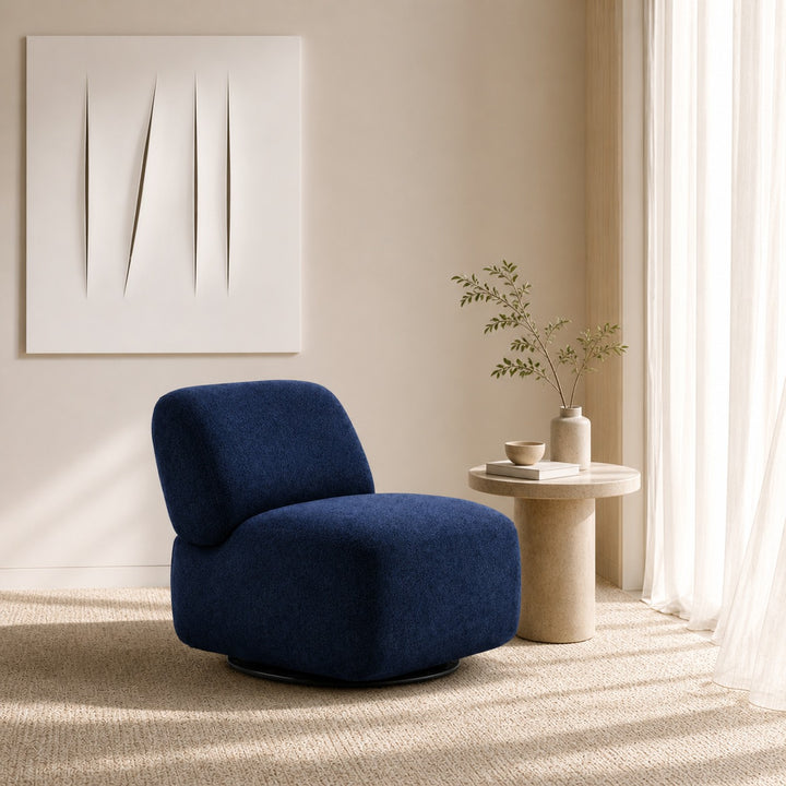 Blue armchair in a modern living room with a side table and plant.