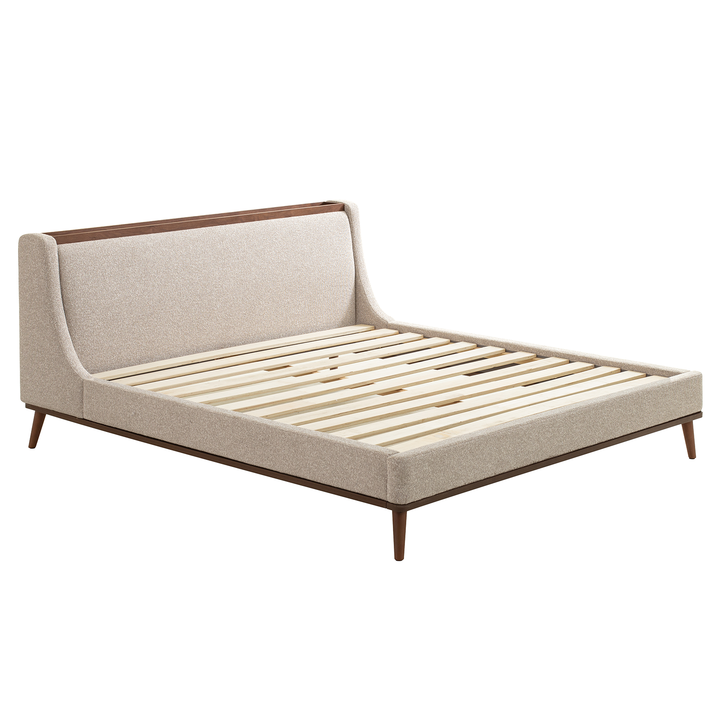 Beige upholstered bed with wooden frame on a white background