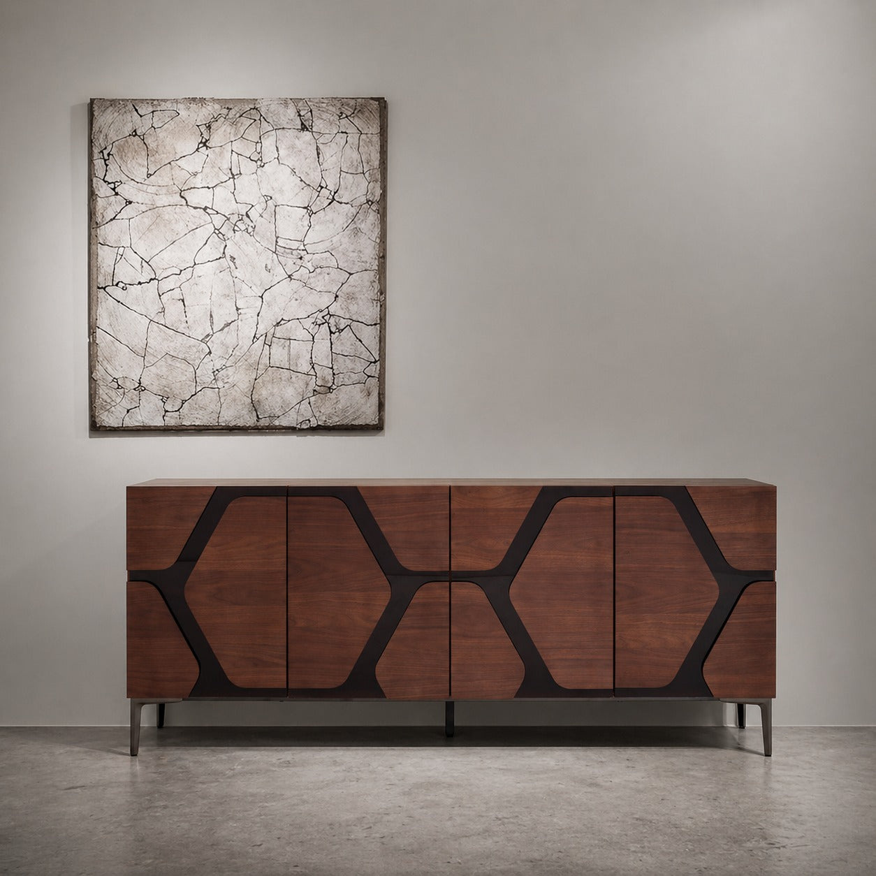 Wooden sideboard with geometric design in a room with a textured wall and abstract painting.