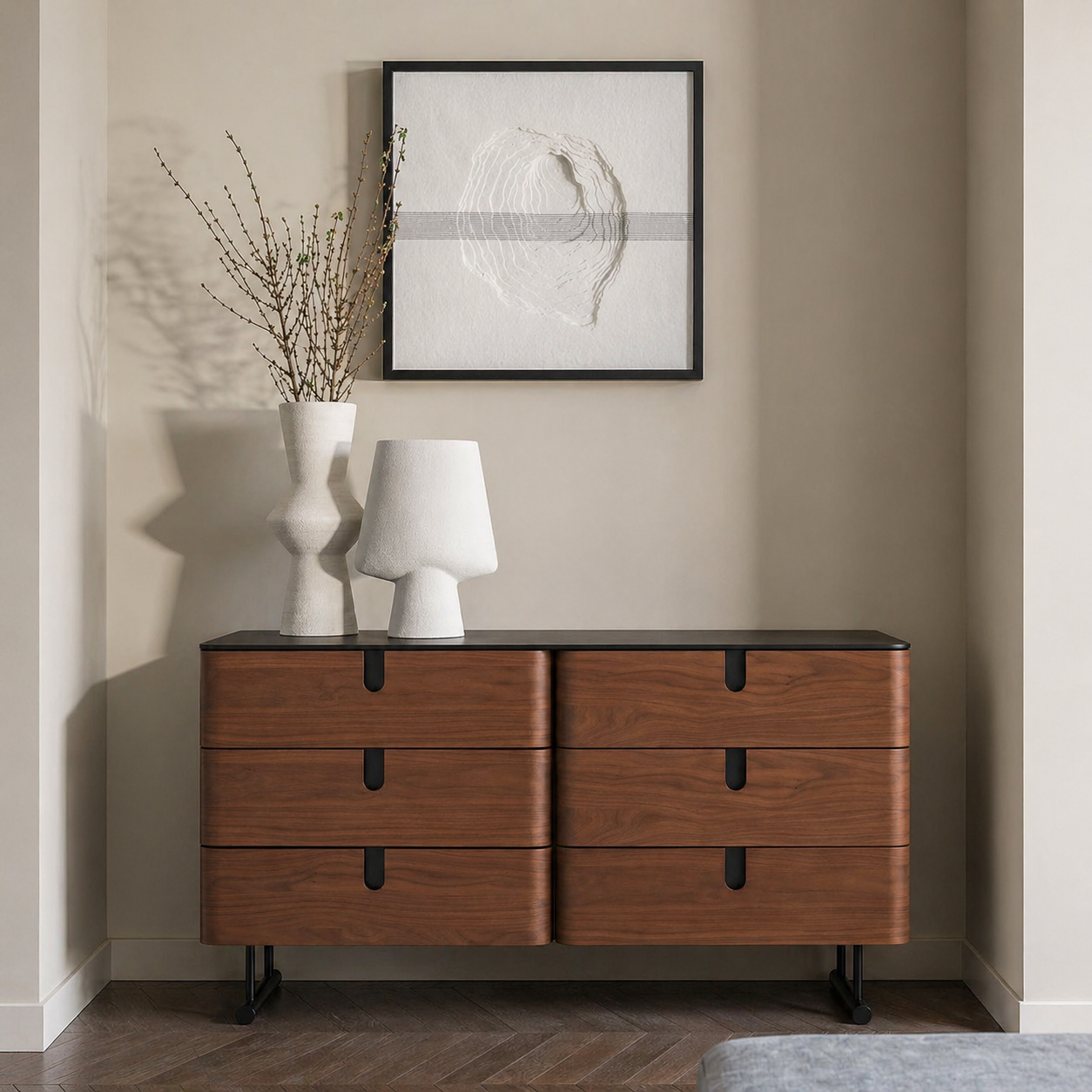 Wooden dresser with three drawers in a room with a lamp and decorative items.