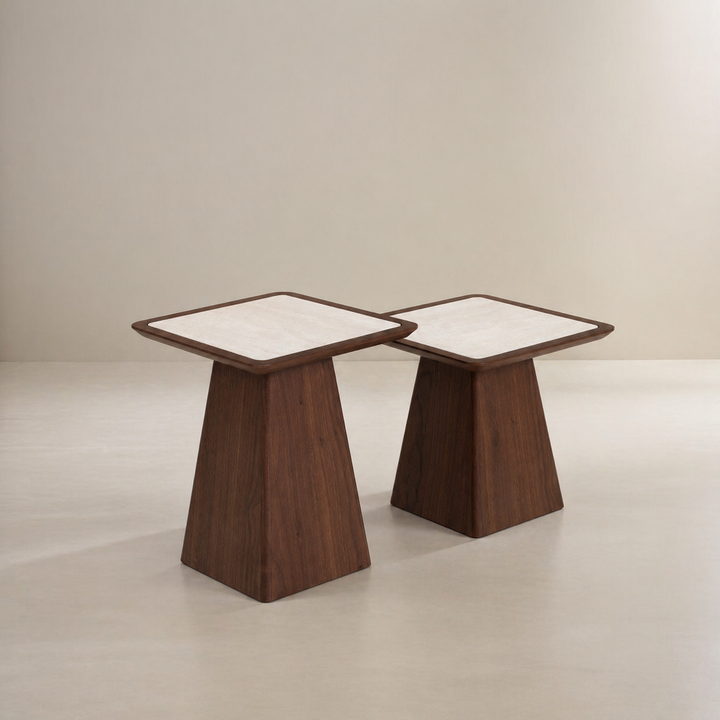 Two wooden side tables with white tops on a plain background