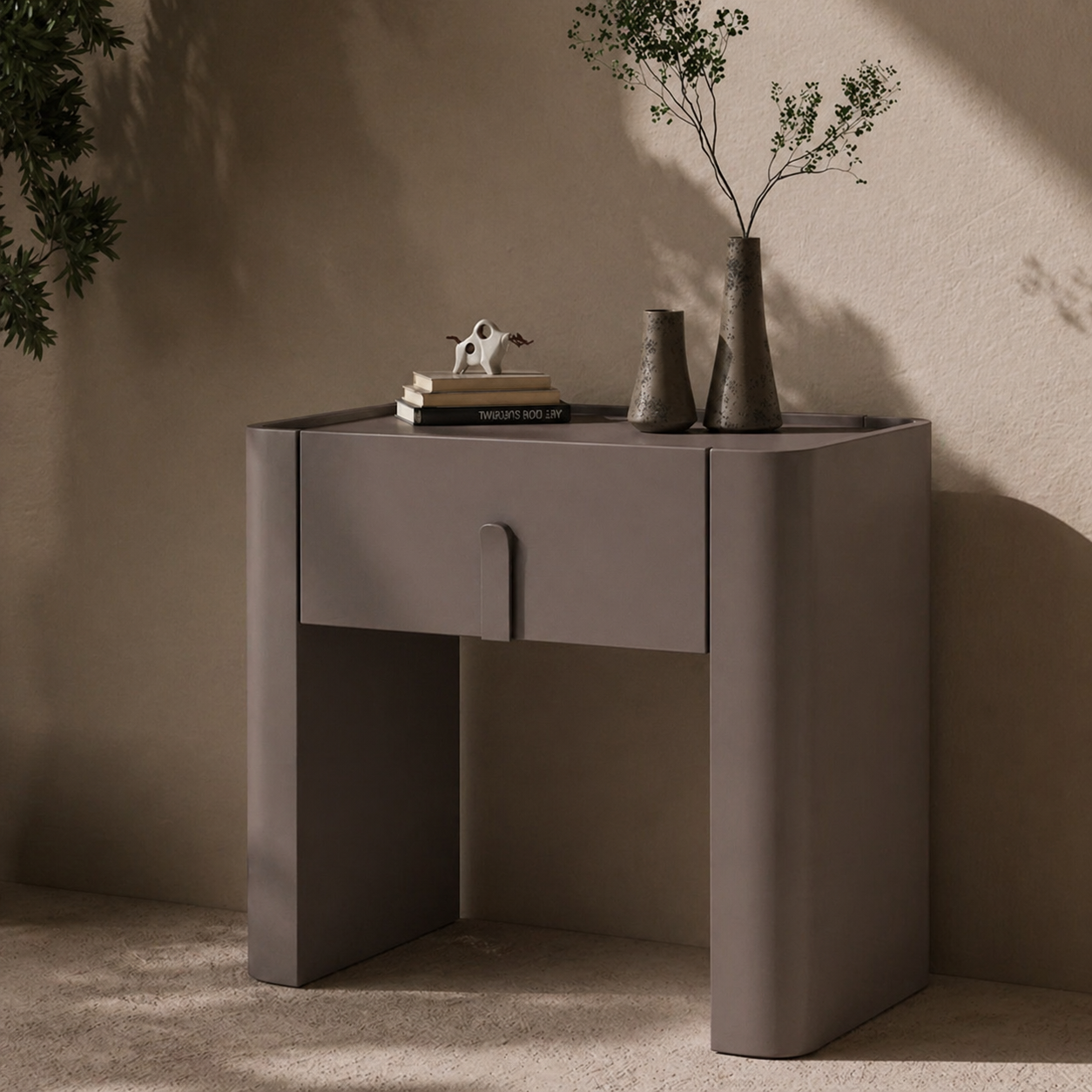Modern side table with decorative items against a beige wall