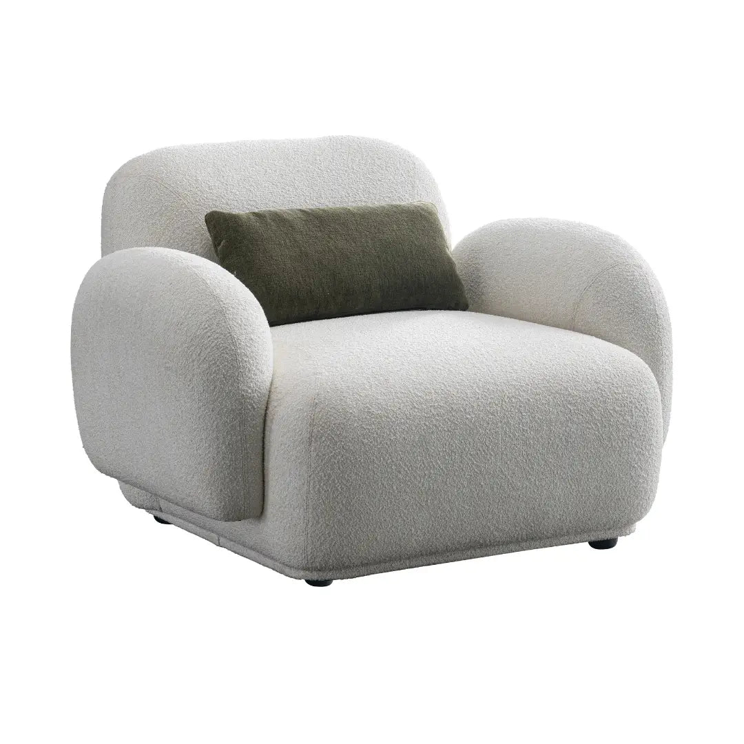 Gray armchair with a green pillow on a white background