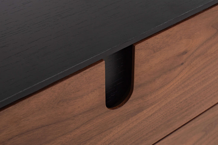 Close-up of a black metal bracket on a wooden surface