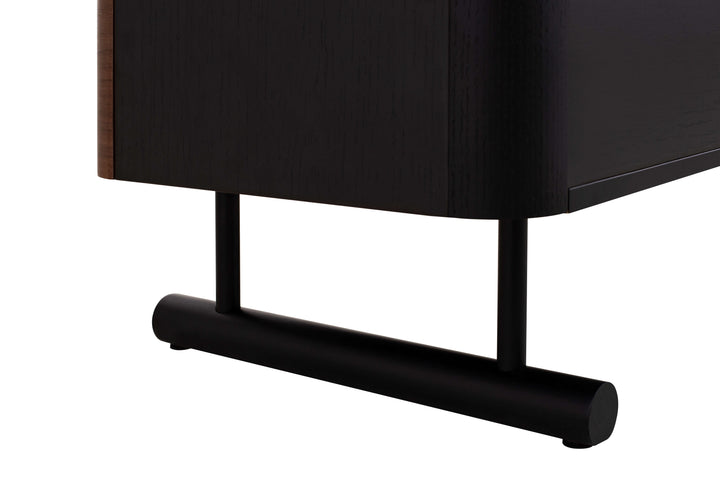Close-up of a black cabinet with cylindrical legs on a white background