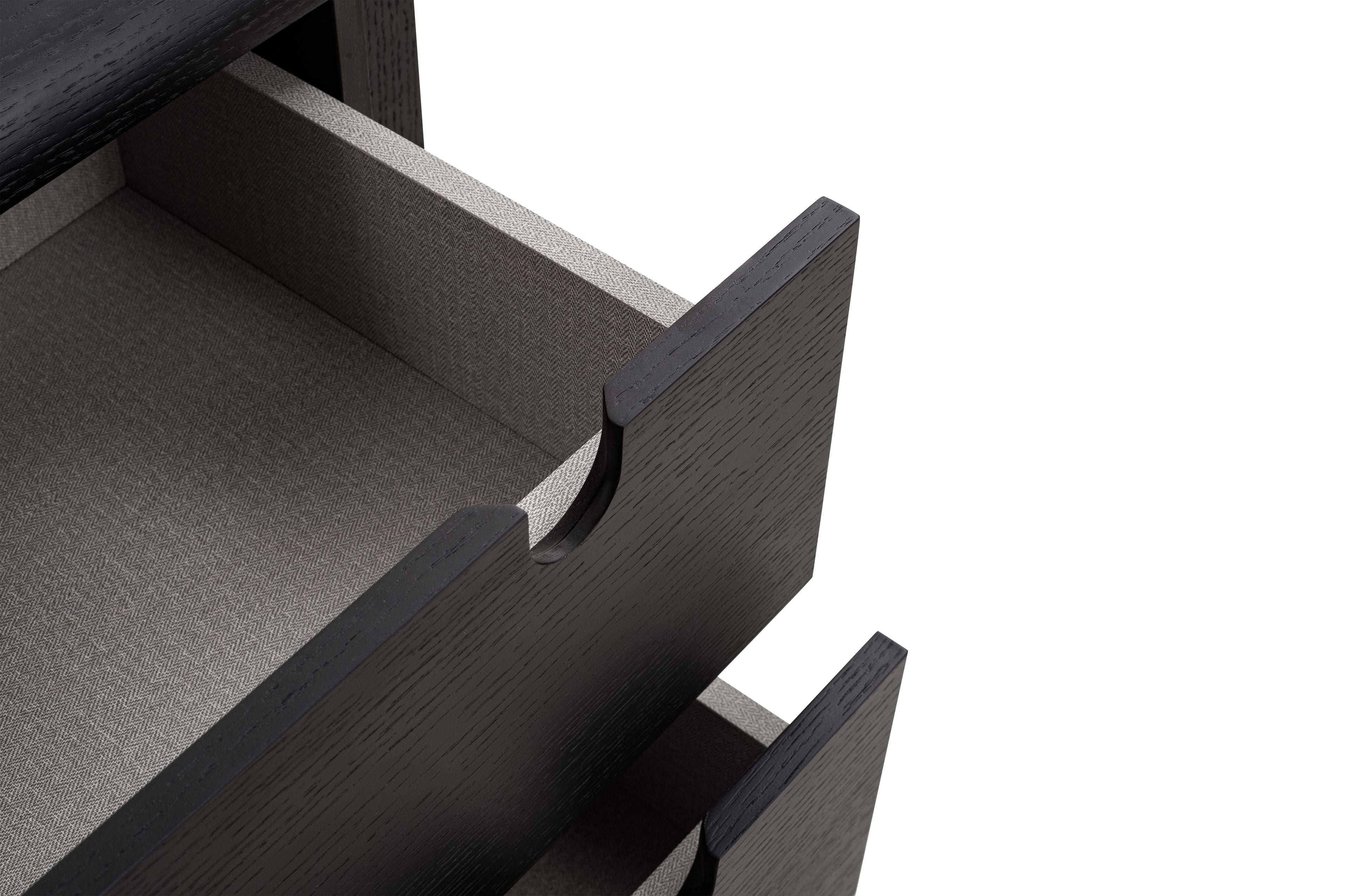 Close-up of an open black drawer on a white background