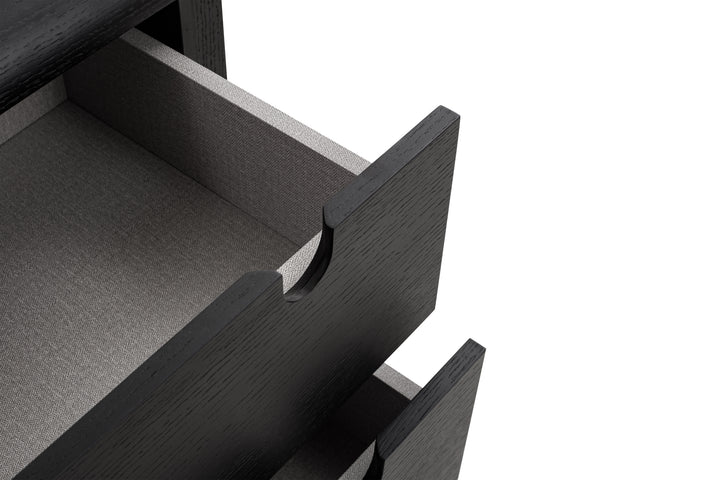 Close-up of an open black drawer on a white background