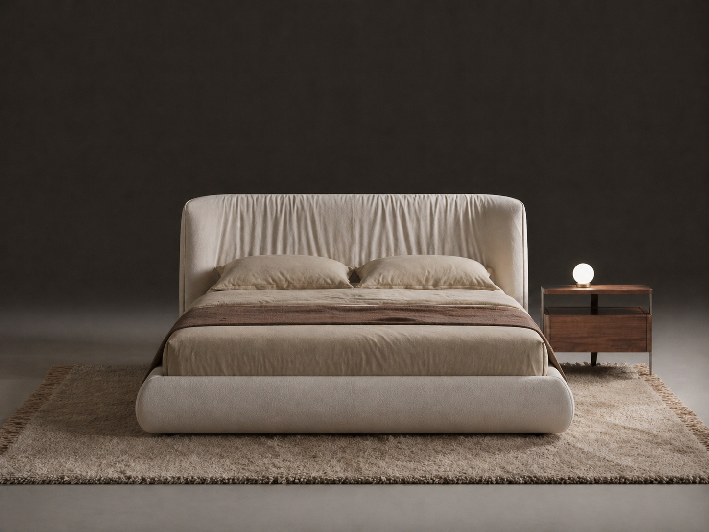 Beige bed with matching headboard and nightstand against a dark wall.