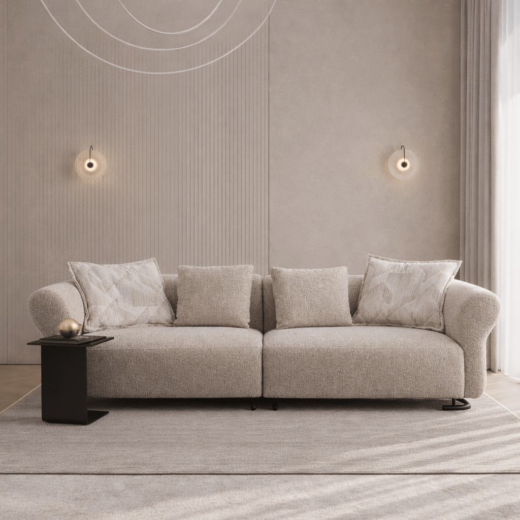 Beige sofa with decorative pillows in a modern living room setting.