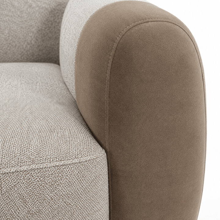 Close-up of a gray and brown upholstered chair armrests.