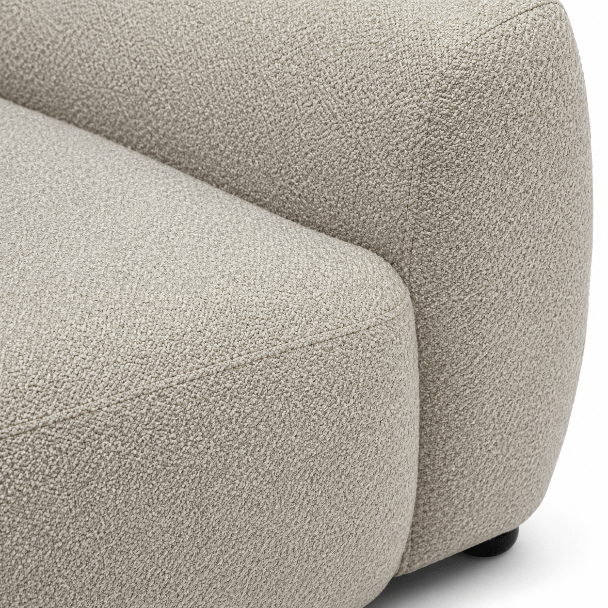 Close-up of a textured beige sofa corner on a white background