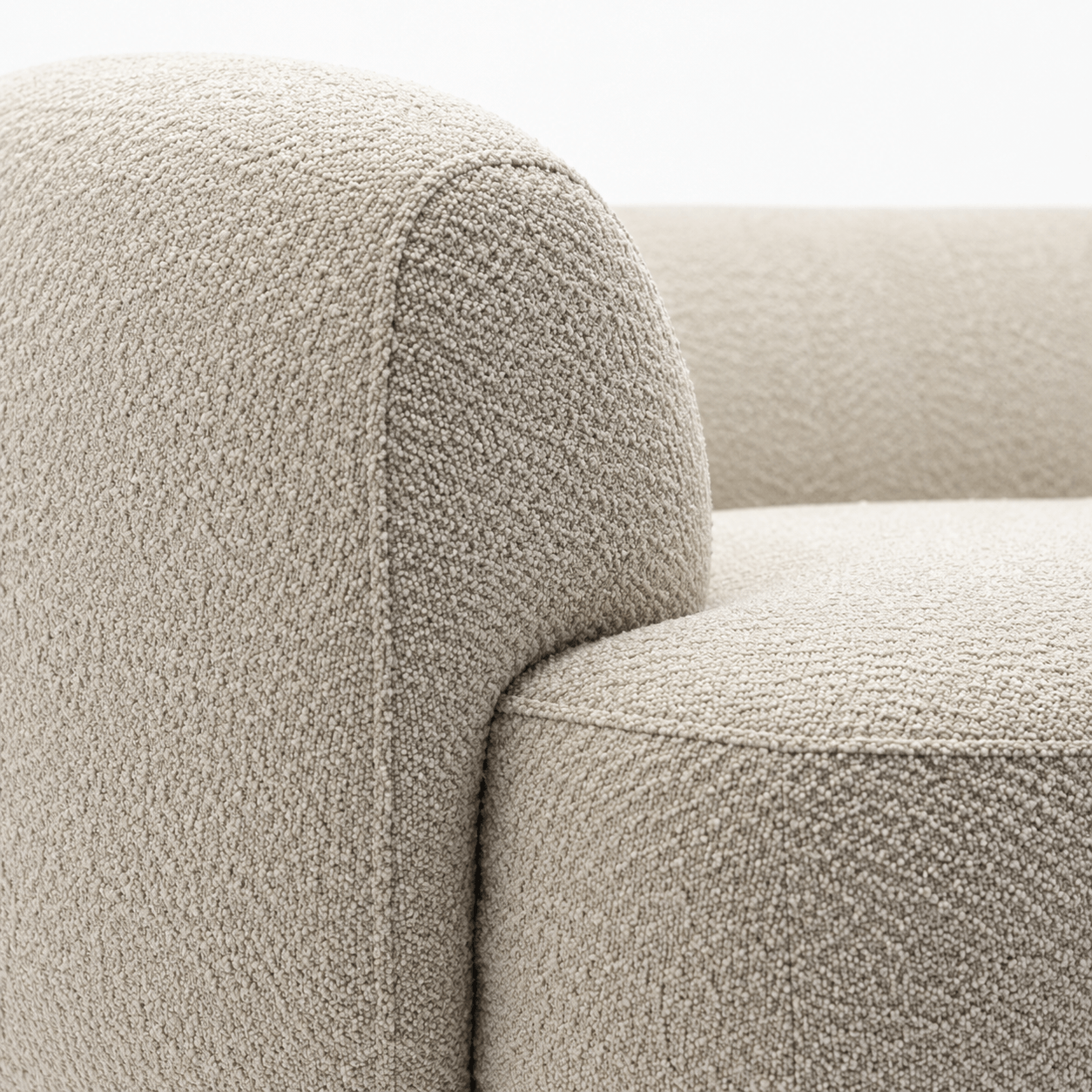 Close-up of a textured beige sofa armrest