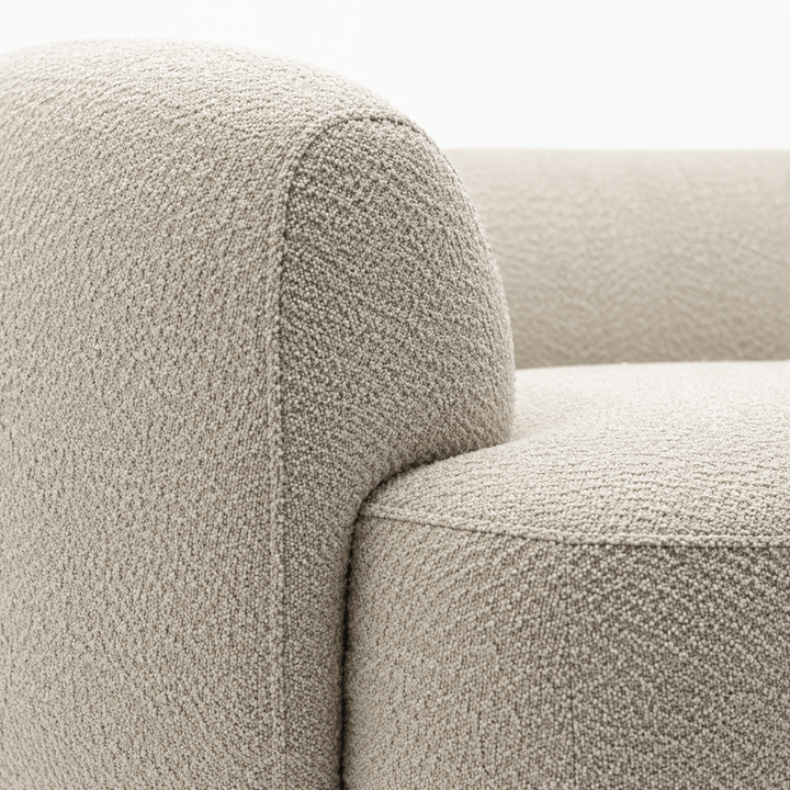 Close-up of a textured beige sofa armrest