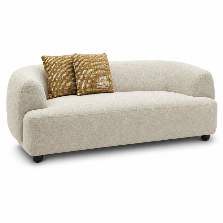 Beige sofa with two gold pillows on a white background