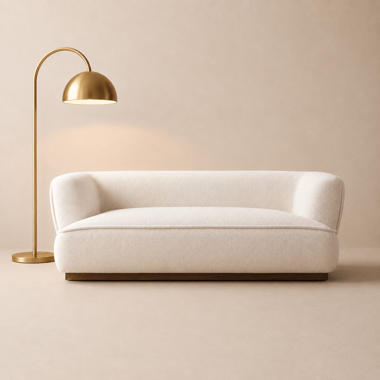 Beige sofa with a gold floor lamp against a beige wall