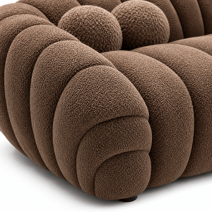 Close-up of a brown textured sofa with a white background