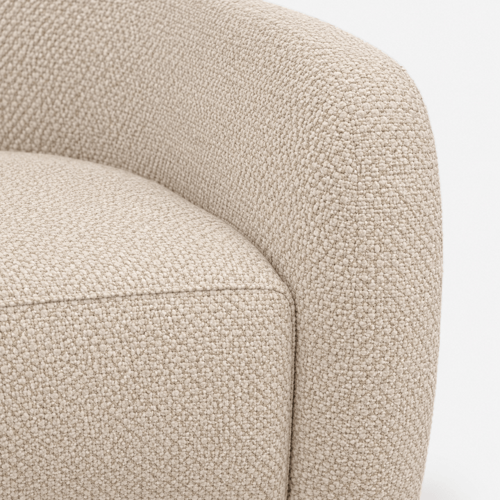 Close-up of a textured beige armchair on a white background
