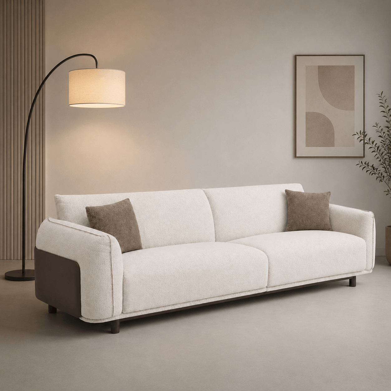 White sofa with brown cushions in a room with a floor lamp and abstract art on the wall.
