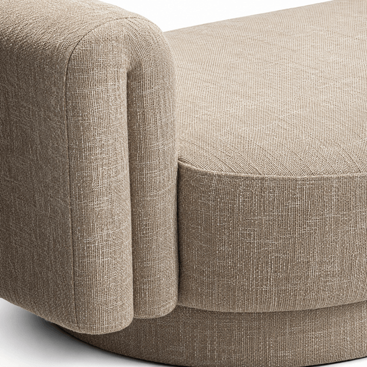 Close-up of a beige upholstered chair with a textured fabric finish.