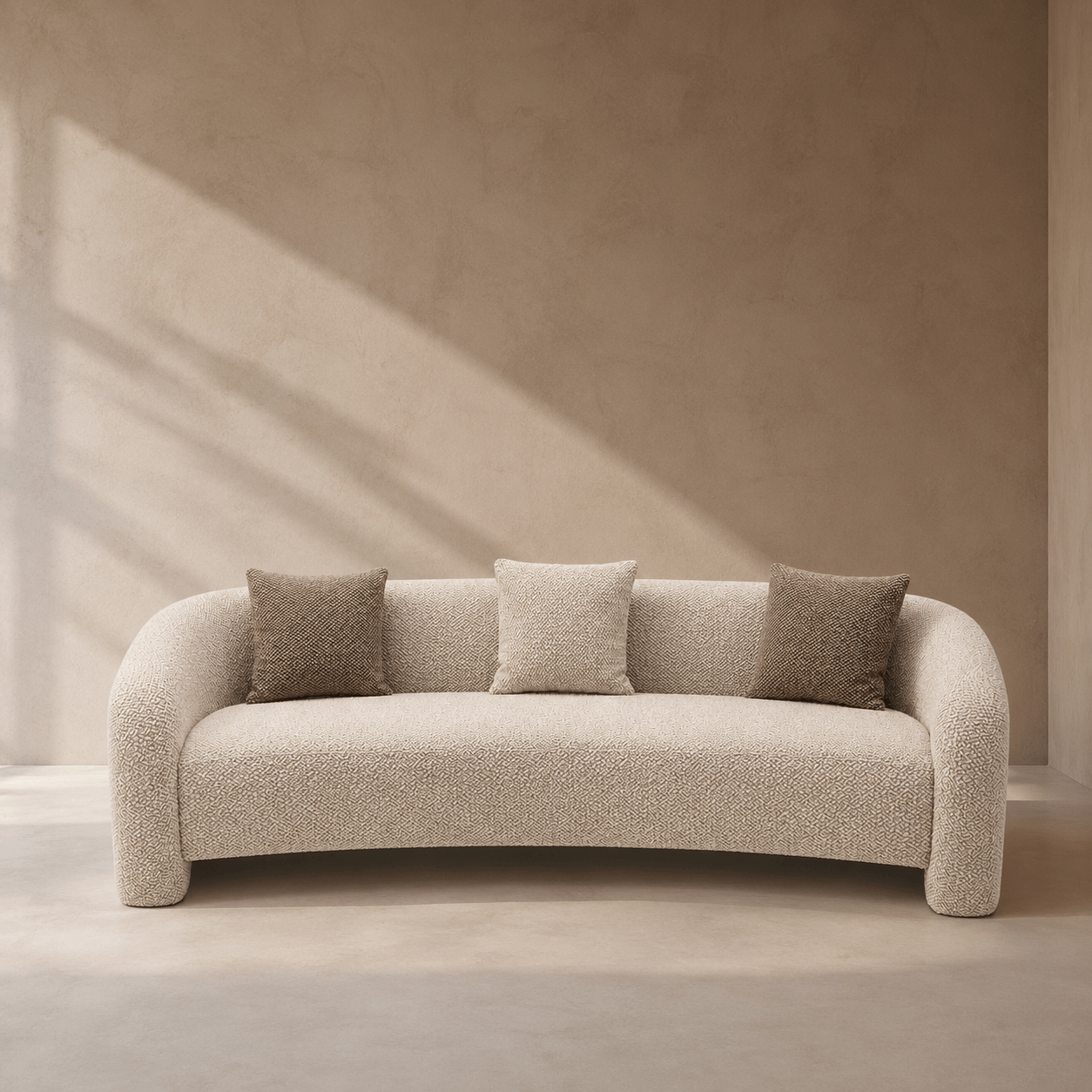 Beige sofa with three cushions in a minimalistic room with soft lighting