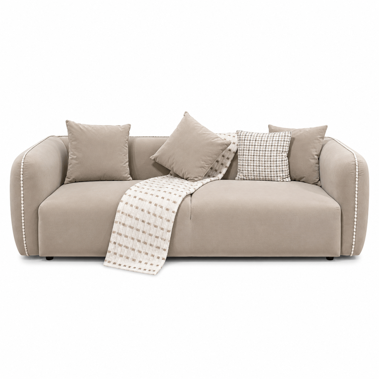 Beige sofa with cushions and a blanket on a white background