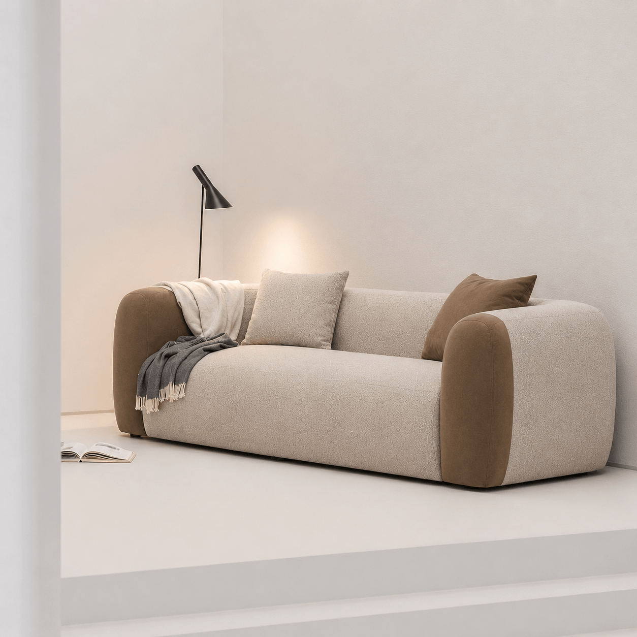 Modern beige sofa with brown accents in a minimalistic room.