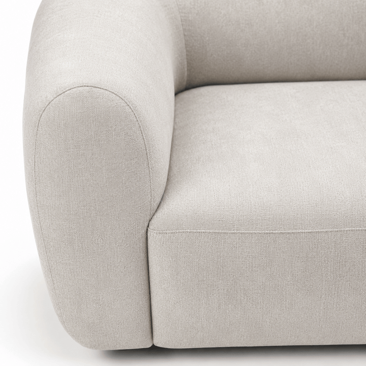 Close-up of a light gray sofa on a white background