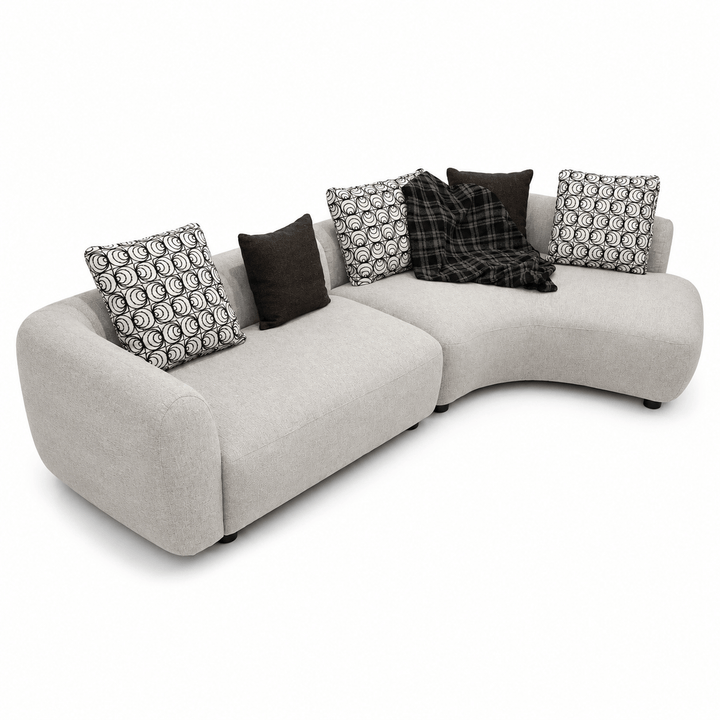 Gray sectional sofa with patterned cushions on a white background
