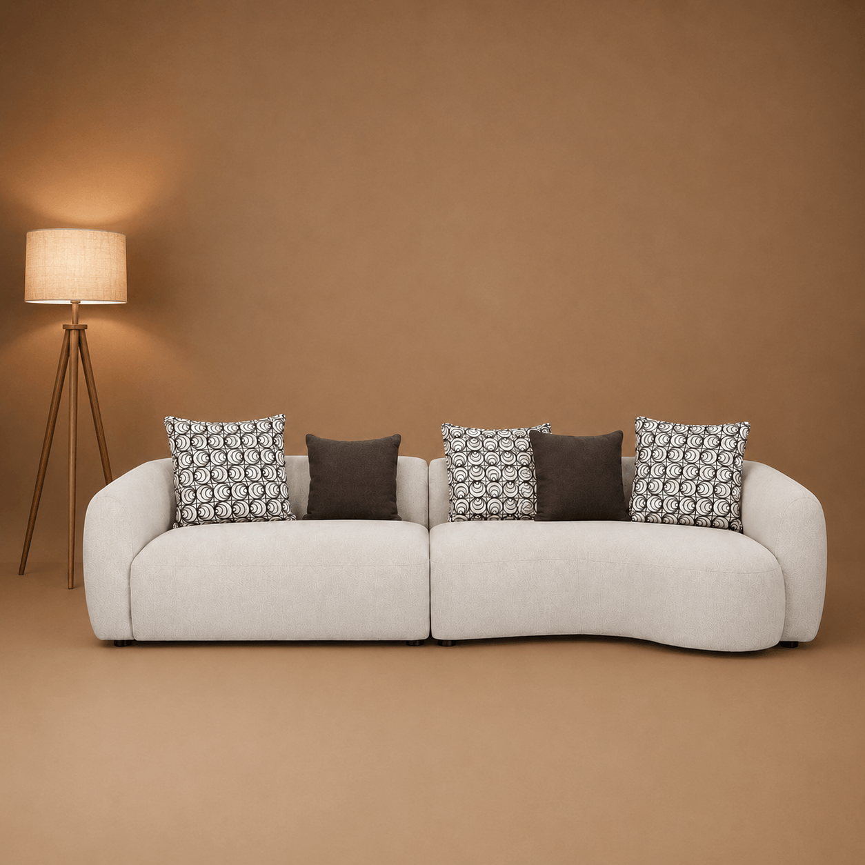 White sofa with patterned cushions against a brown wall with a floor lamp.