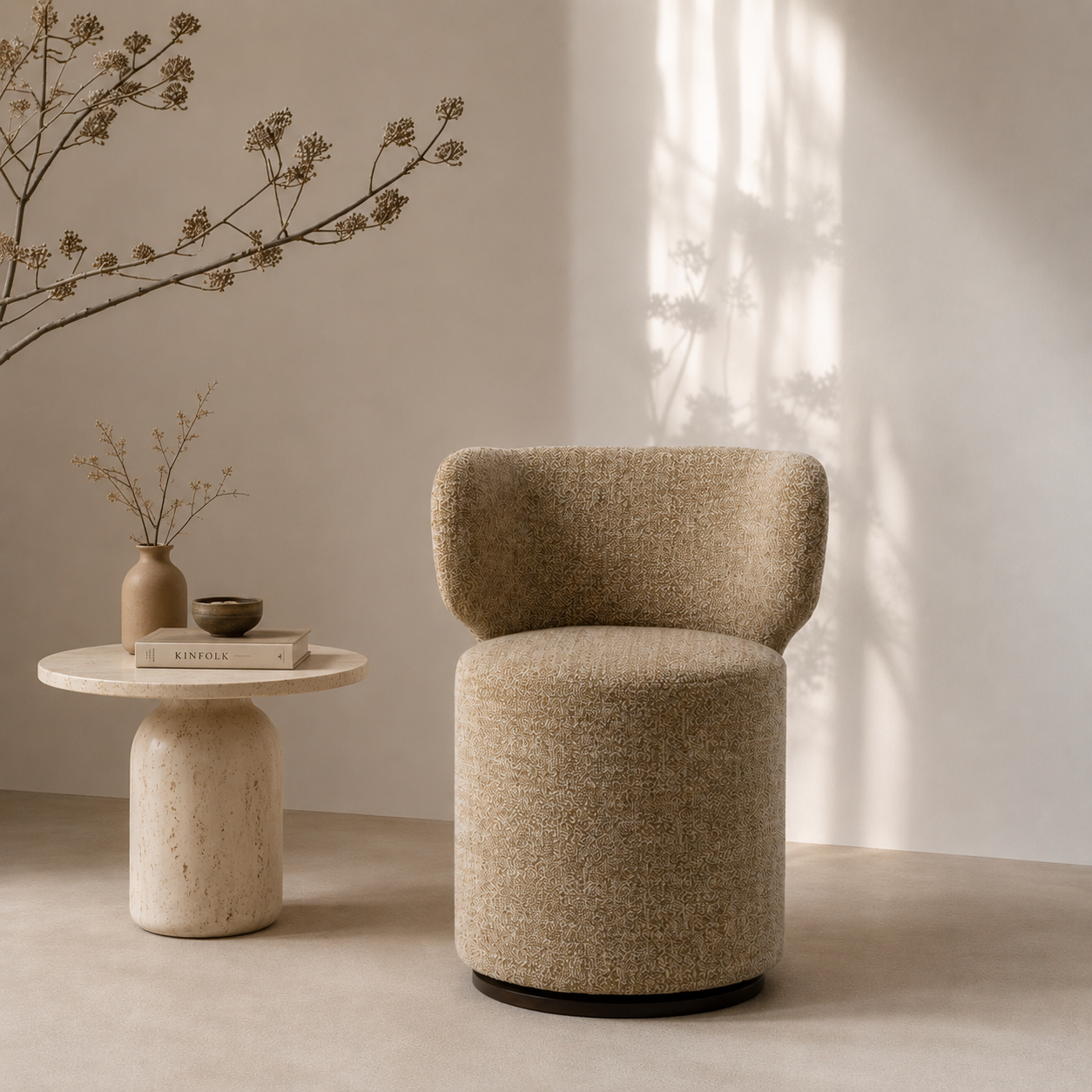 Beige armchair next to a small round table with decorative items in a softly lit room.