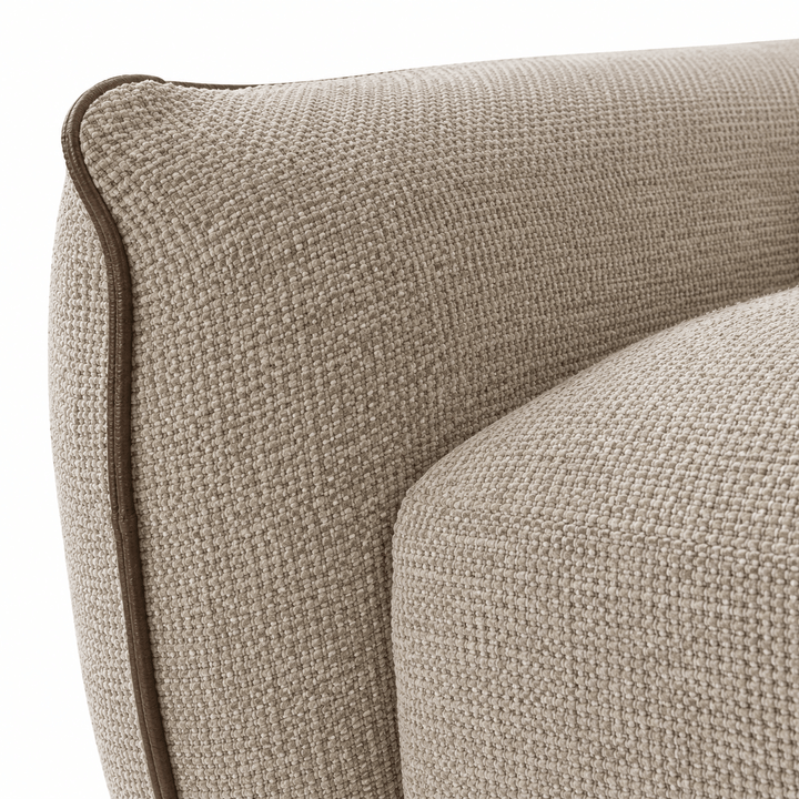 Close-up of a textured beige sofa corner on a white background