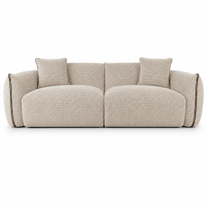 Beige sofa with two cushions on a white background