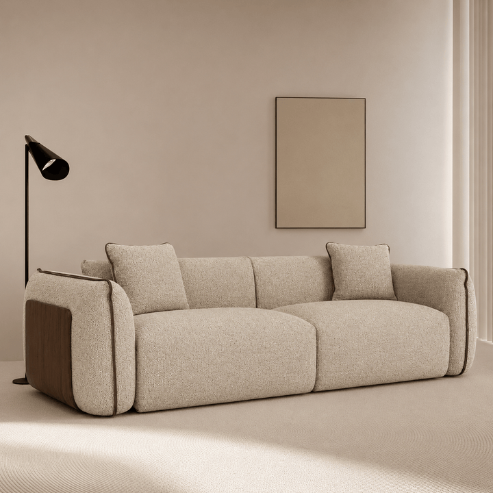 Beige sofa in a minimalistic room with a lamp and wall art.