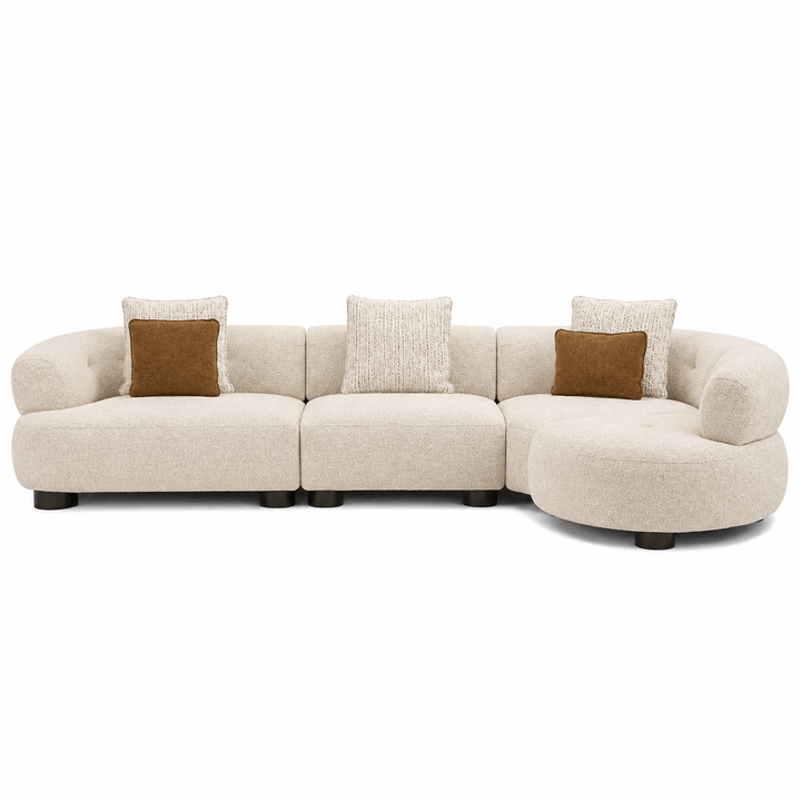 Beige sectional sofa with brown and beige cushions on a white background