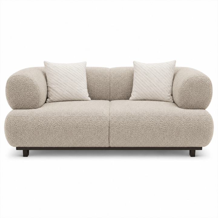 Beige sofa with two white pillows on a white background