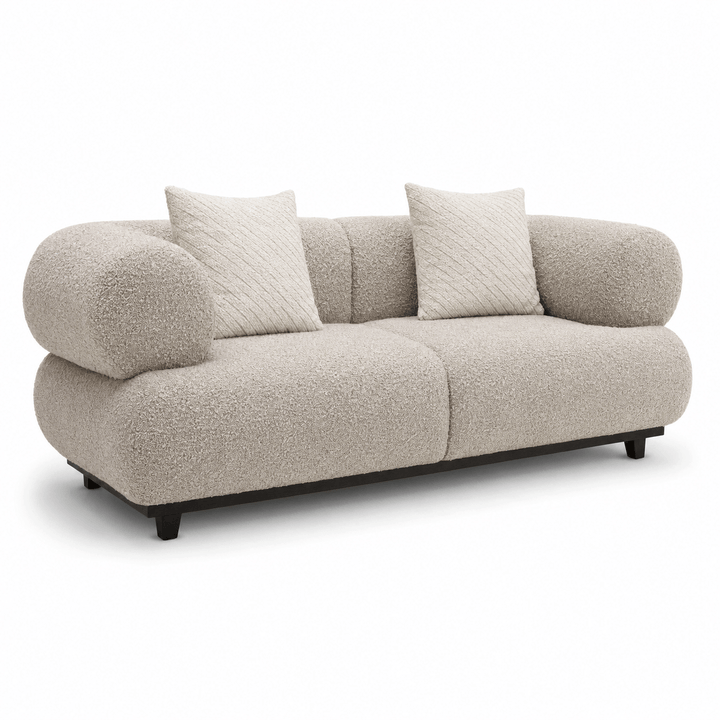 Beige sofa with two cushions on a white background