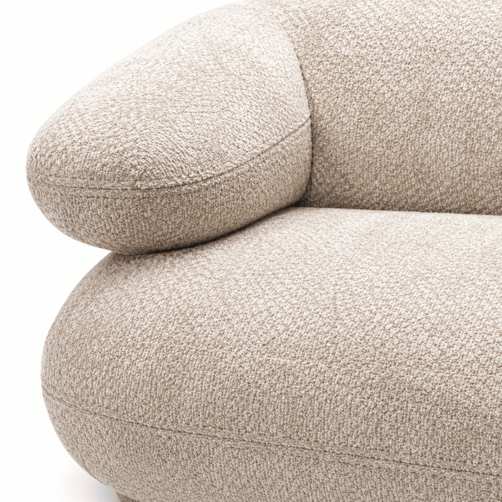 Close-up of a textured beige sofa on a white background