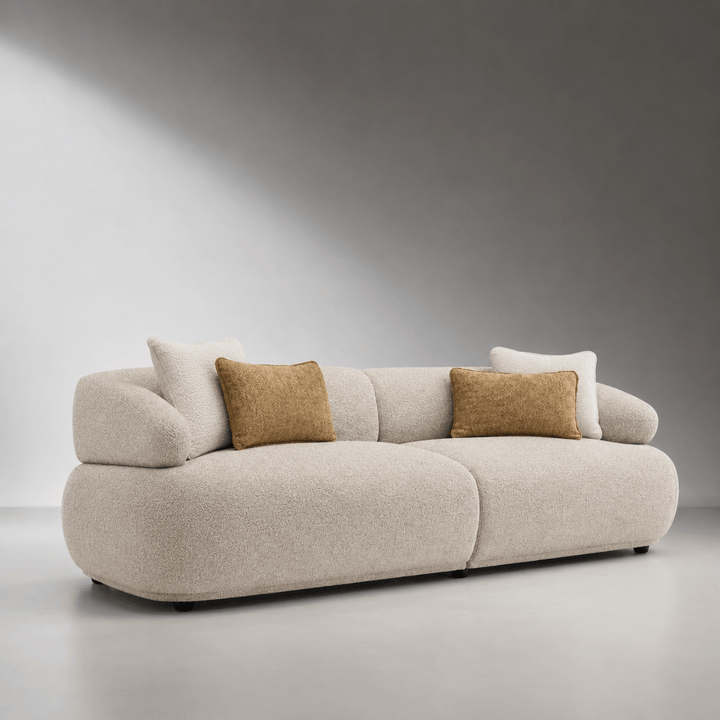 Beige sofa with brown cushions on a gray background