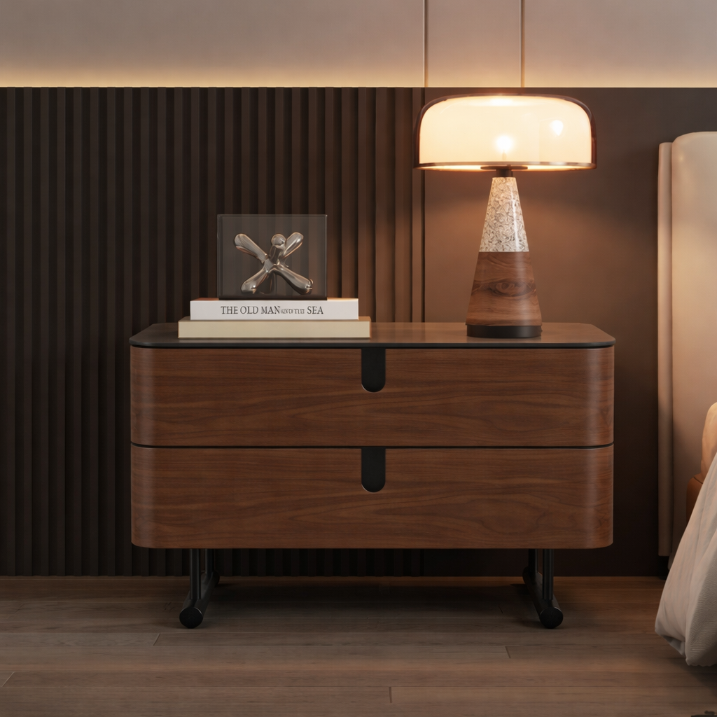 Wooden nightstand with a lamp and books in a bedroom setting