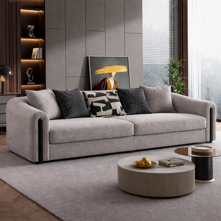 Gray sofa in a modern living room with decorative pillows and a coffee table.