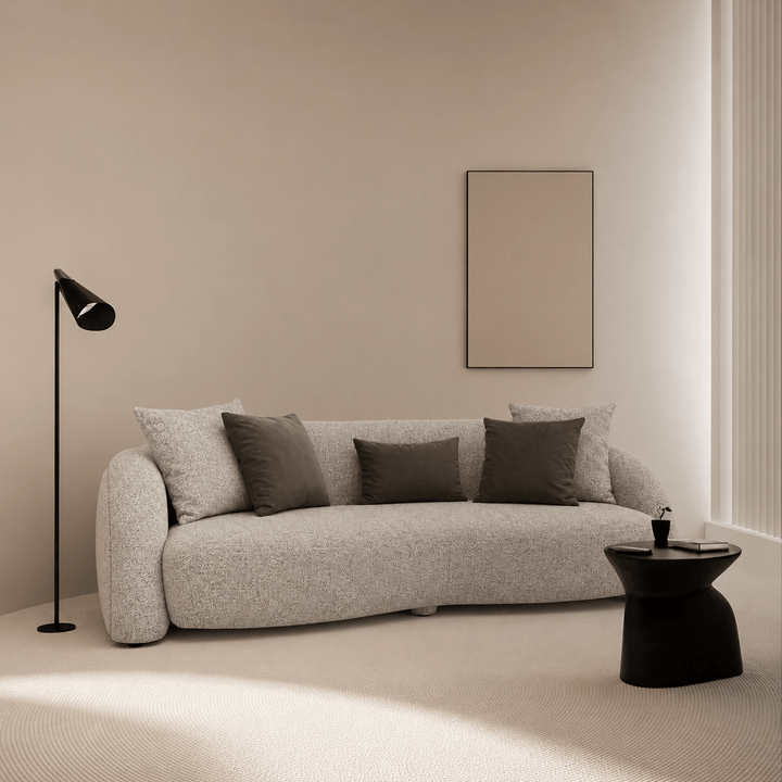 Modern living room with a gray sofa, black floor lamp, and small black table.